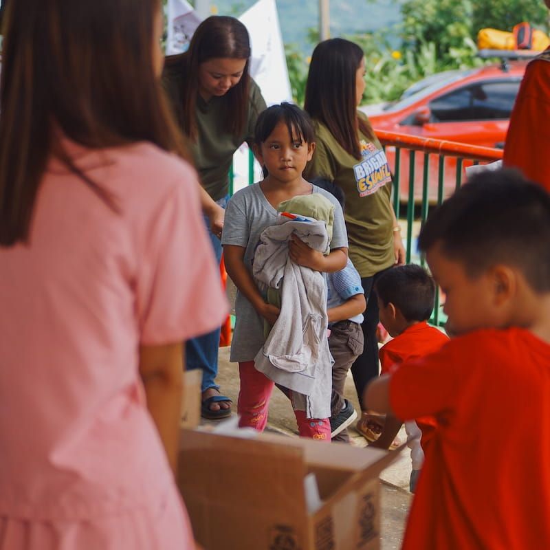 Student holding the used clothes gift