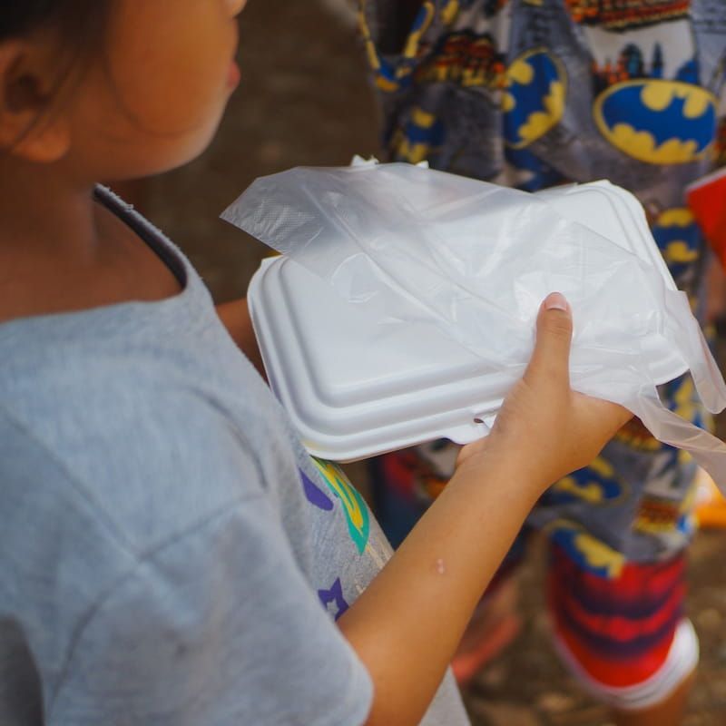 Student holding a food pack