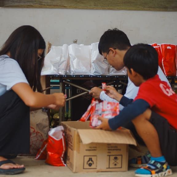 Kids preparing items from a box